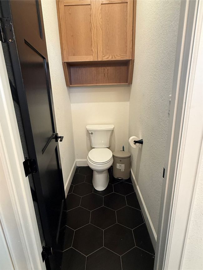 Bathroom featuring a textured wall and tile patterned flooring | Image 17