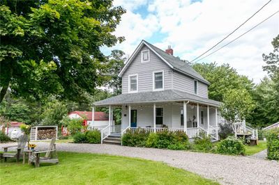 Farmhouse-style home with a front yard and a porch | Image 2