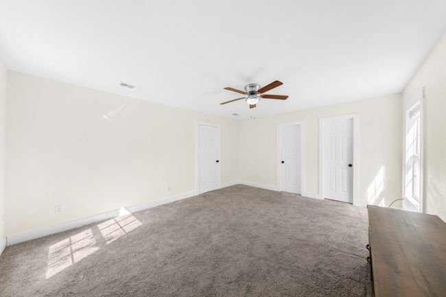 Carpeted spare room with a ceiling fan and baseboards | Image 15