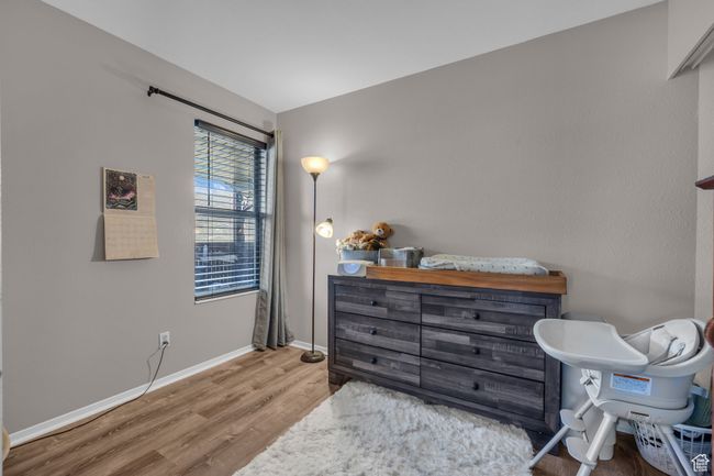 Bedroom featuring baseboards and wood finished floors | Image 12