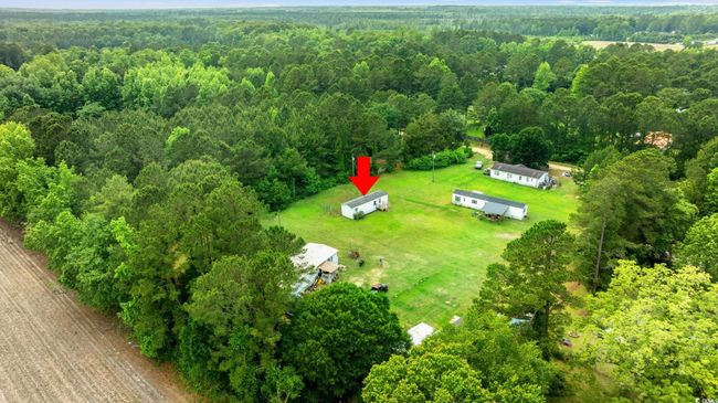 Aerial view of property and surrounding area featuring a heavily wooded area | Image 31