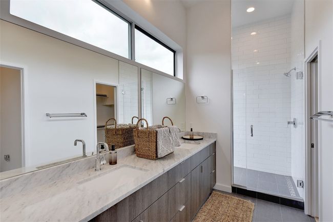 Bathroom featuring a sink, tile patterned flooring, double vanity, and a stall shower | Image 14