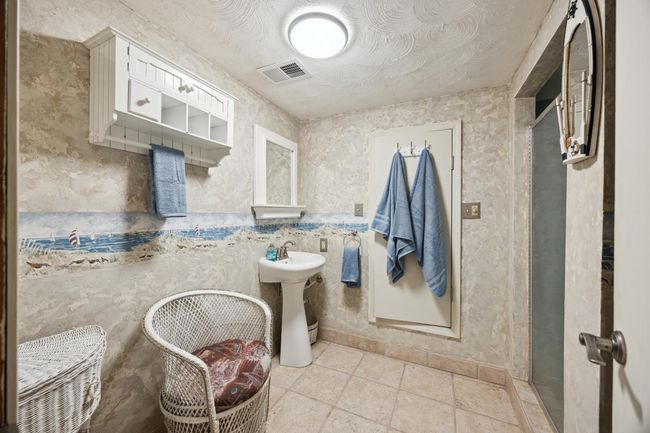 This is the bath on the lower level. The room that the two towels are hanging is the sauna with a shower to the right on this photo. | Image 21