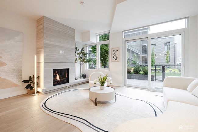 Living room featuring a fireplace, baseboards, and wood finished floors | Image 5