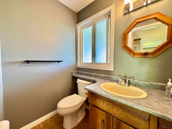 Half bathroom featuring vanity and wood finished floors | Image 9