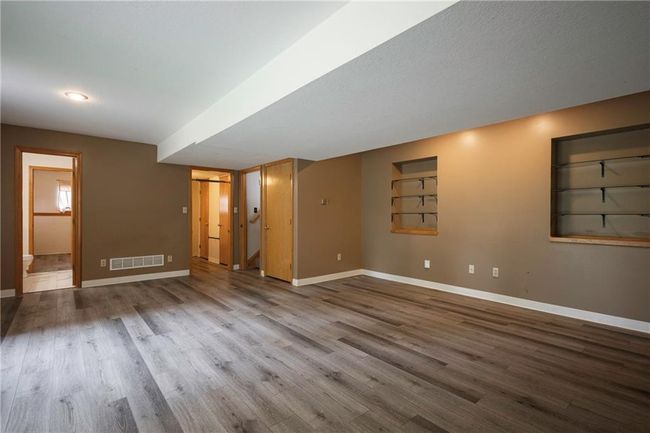 Empty room with baseboards and wood finished floors | Image 28