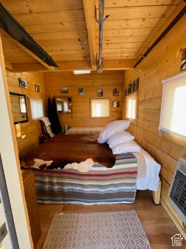 Bedroom with log walls, multiple windows, wood ceiling, and beam ceiling | Image 124