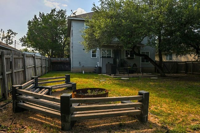 Back of house featuring a fenced backyard, a patio area and fire pit with benches | Image 17