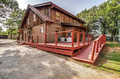 Rear view of property featuring a wood deck. | Image 2