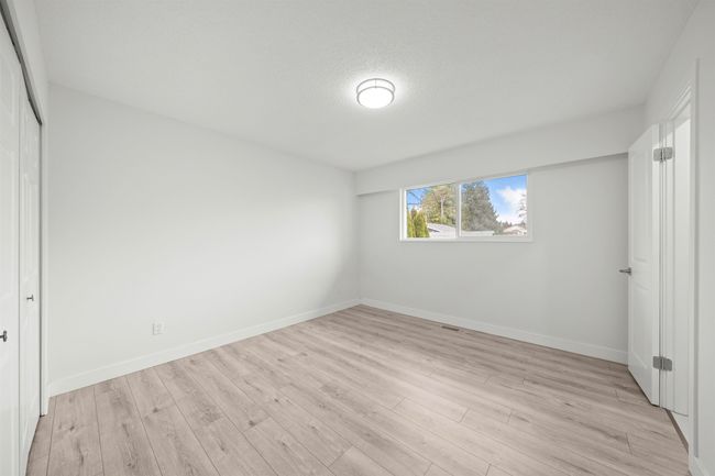 Unfurnished bedroom with a closet, baseboards, and light wood-style floors | Image 15