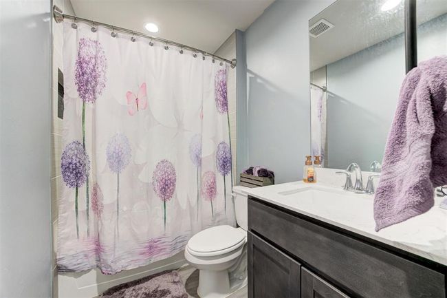 Bathroom featuring vanity and shower / tub combo with curtain | Image 34