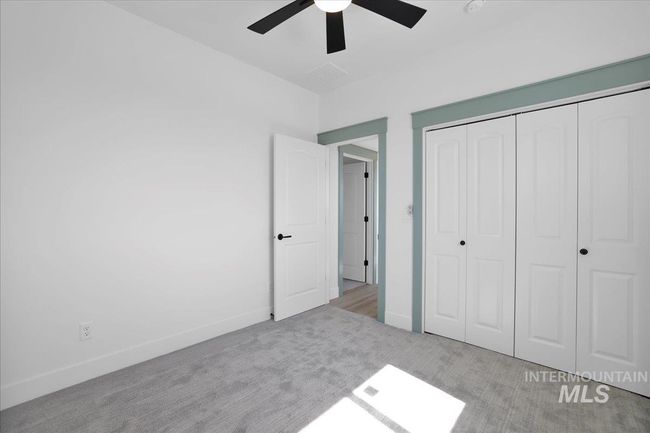 Unfurnished bedroom with carpet, a closet, and ceiling fan | Image 34