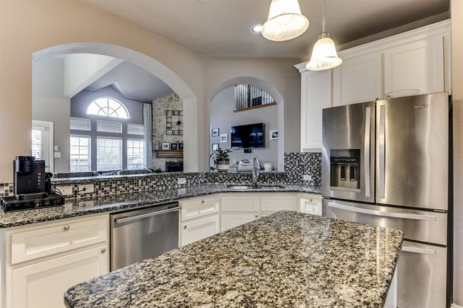 Kitchen featuring white cabinets, sink, and appliances with stainless steel finishes | Image 21