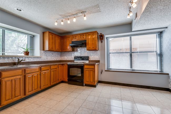 Kitchen featuring track lighting. | Image 7