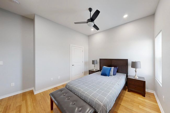 Bedroom featuring light wood-type flooring, baseboards, recessed lighting, and a ceiling fan | Image 14