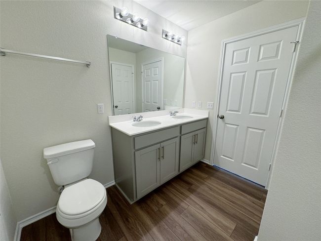 Bathroom with wood finished floors, toilet, and double vanity | Image 20