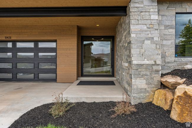 Doorway to property with stone siding | Image 64