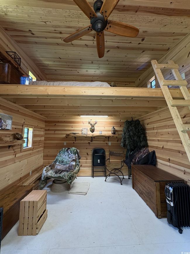 Bedroom with wood walls and wood ceiling | Image 31