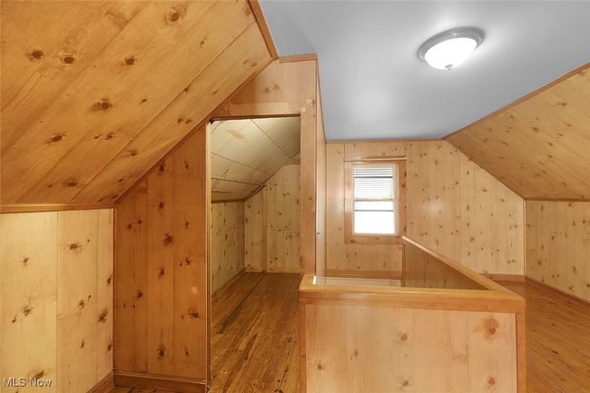 primary bedroom with vaulted ceiling and wood-type flooring | Image 21