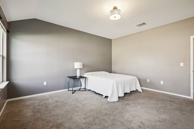 Bedroom featuring lofted ceiling and carpet | Image 17
