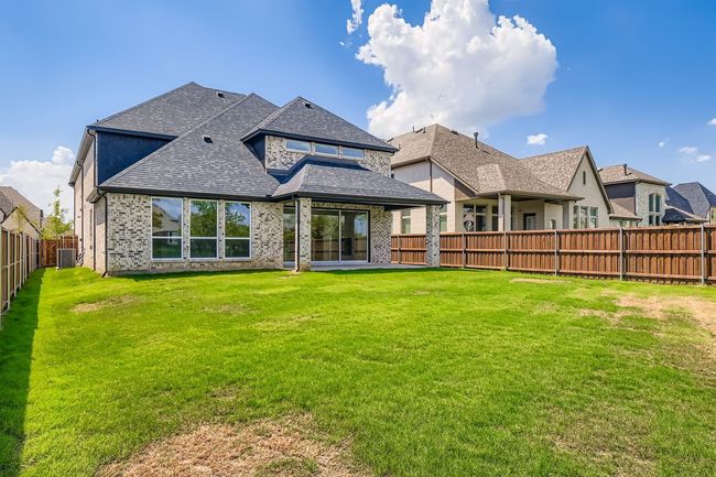 Back of property featuring a shingled roof, a fenced backyard, a patio area, and brick siding | Image 28