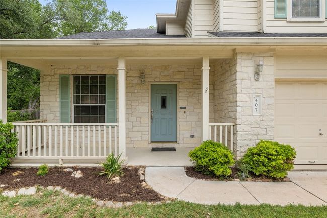 View of exterior entry with a porch, an attached garage, roof with shingles, and stone siding | Image 4