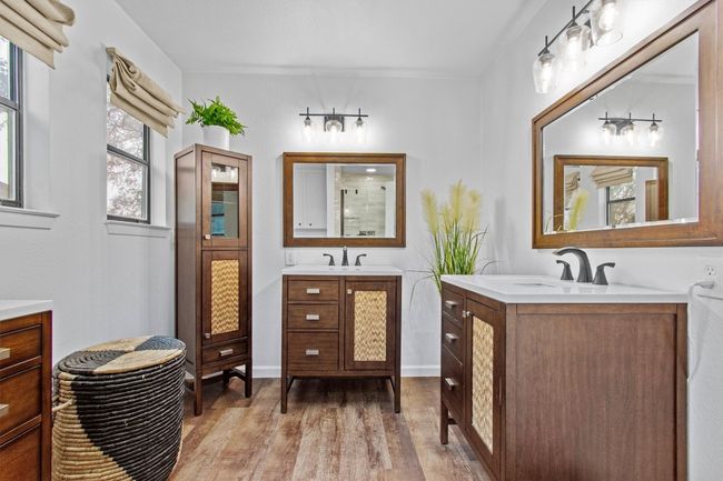 Bathroom featuring walk in shower, vanity, and wood-type flooring | Image 25