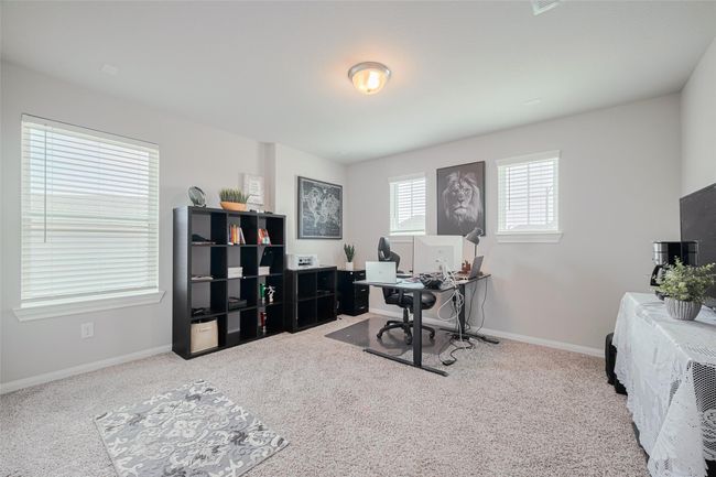 Bright and spacious home office with carpeted flooring and ample natural light from multiple windows. Ideal for remote work or study. | Image 37