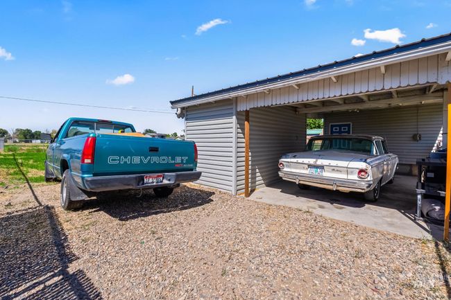 View of vehicle parking featuring driveway and an attached carport | Image 23