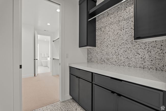 Bathroom with dark speckled floor, recessed lighting, and vanity | Image 48