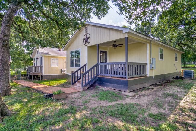 View of front of house featuring a ceiling fan and a porch | Image 5