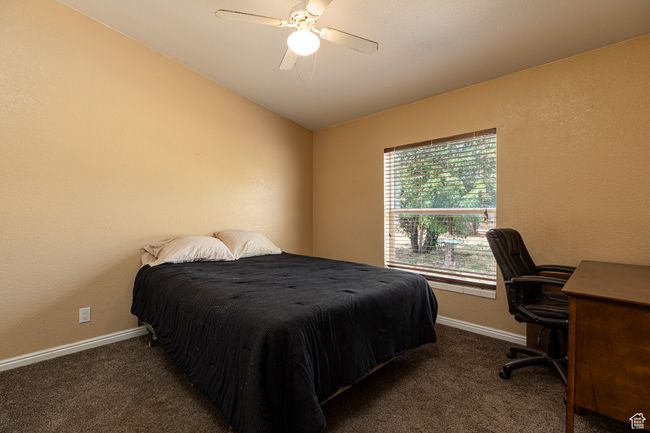 Carpeted bedroom featuring vaulted ceiling and ceiling fan | Image 18
