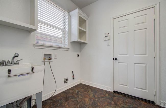 Large utility room with built in shelves and separate sink. | Image 36