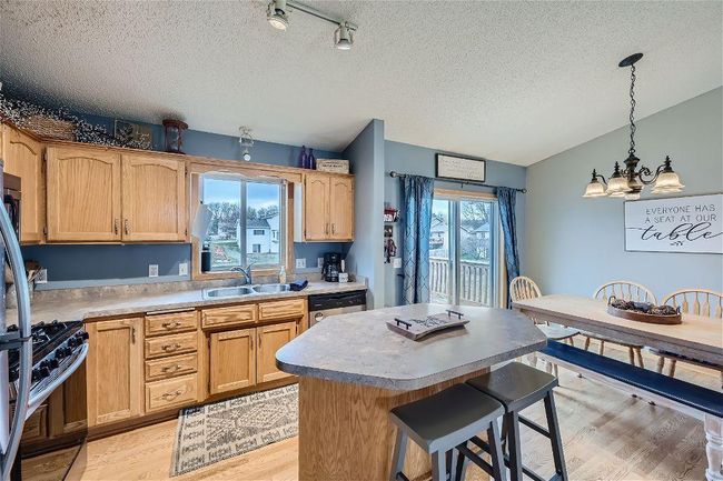 The center island not only provides ample room for meal prep but also offers a cozy spot for enjoying breakfast or a quick bite! | Image 10
