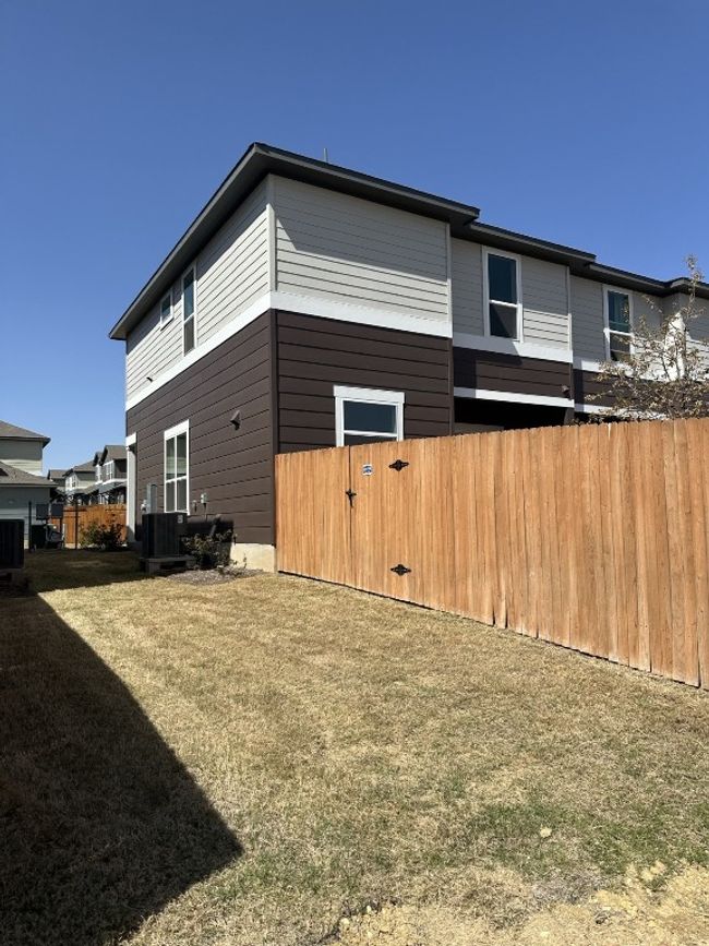 View of side of home featuring cooling unit, fence, and a yard | Image 15