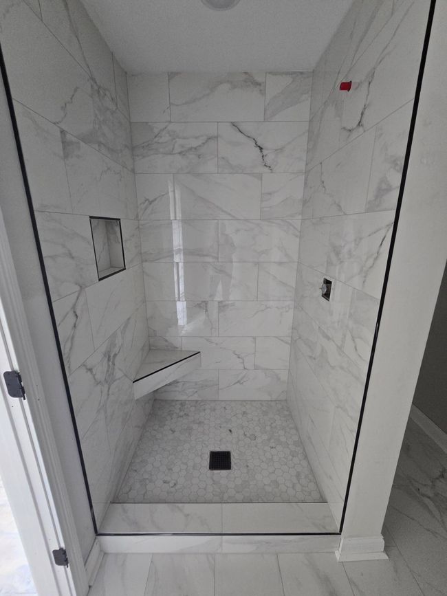 Custom tile shower will have a sleek glass shower door | Image 22