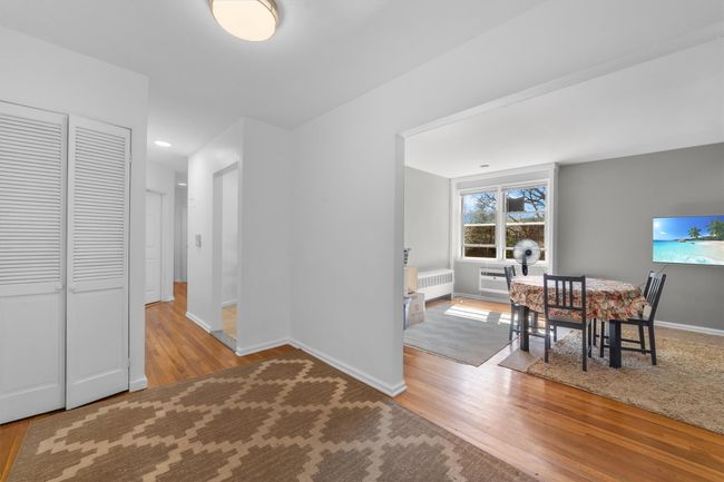 Dining area featuring radiator, baseboards, and wood finished floors | Image 8