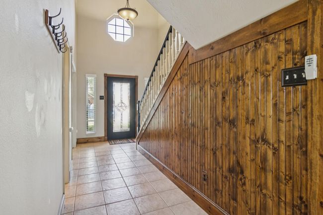 Entry way with tile floors. The beadboard adds a hint of rustic charm. | Image 4