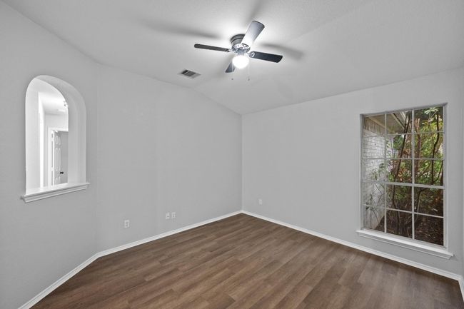 Spare room with a ceiling fan, finished floors, vaulted ceiling, and arched walkways | Image 11