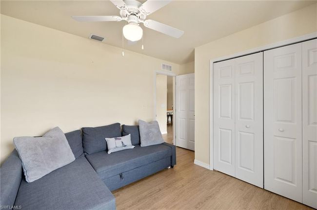 Living area featuring baseboards, visible vents, light wood-style floors, and a ceiling fan | Image 18