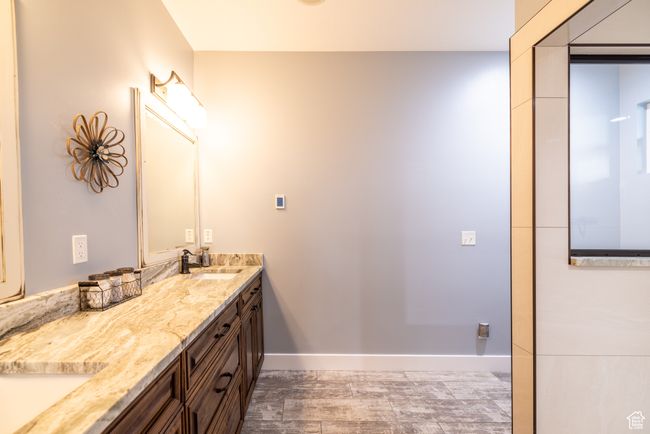 Bathroom featuring double vanity and wood finished floors | Image 32