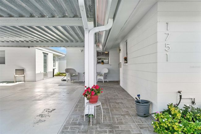 View of covered breezeway to right of carport and covered patio in rear. | Image 2