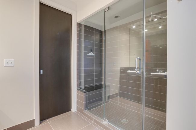 Bathroom featuring a stall shower and tile patterned floors | Image 36