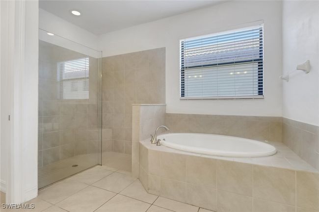 Full bathroom featuring a bath, tile patterned flooring, and walk in shower | Image 14