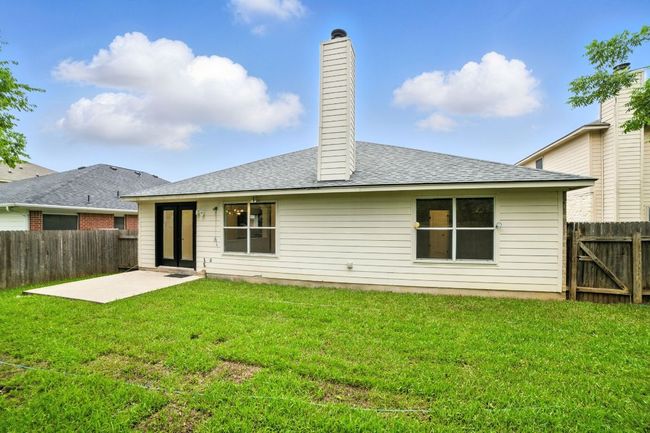 Step outside to a private backyard oasis with a concrete patio, new sod, and a full wood privacy fence—ideal for relaxing or entertaining outdoors. | Image 28