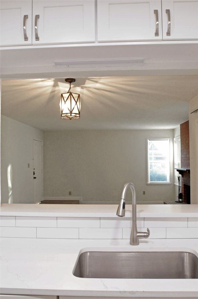 Kitchen featuring sink and white cabinetry | Image 15