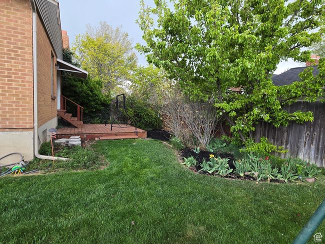 View of yard with fence and a wooden deck | Image 5