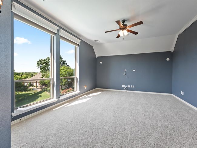 Spare room with ceiling fan, carpet flooring, vaulted ceiling, and ornamental molding | Image 33