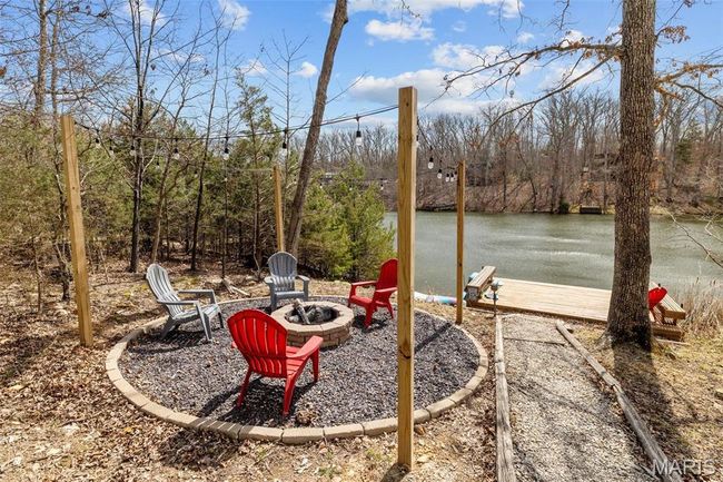 View of yard featuring a forest view, a water view, and an outdoor fire pit | Image 66