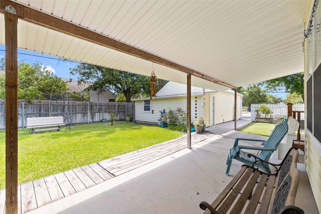 View of fenced backyard and detached 2 car garage. Located inside the garage is an additional workspace. | Image 32